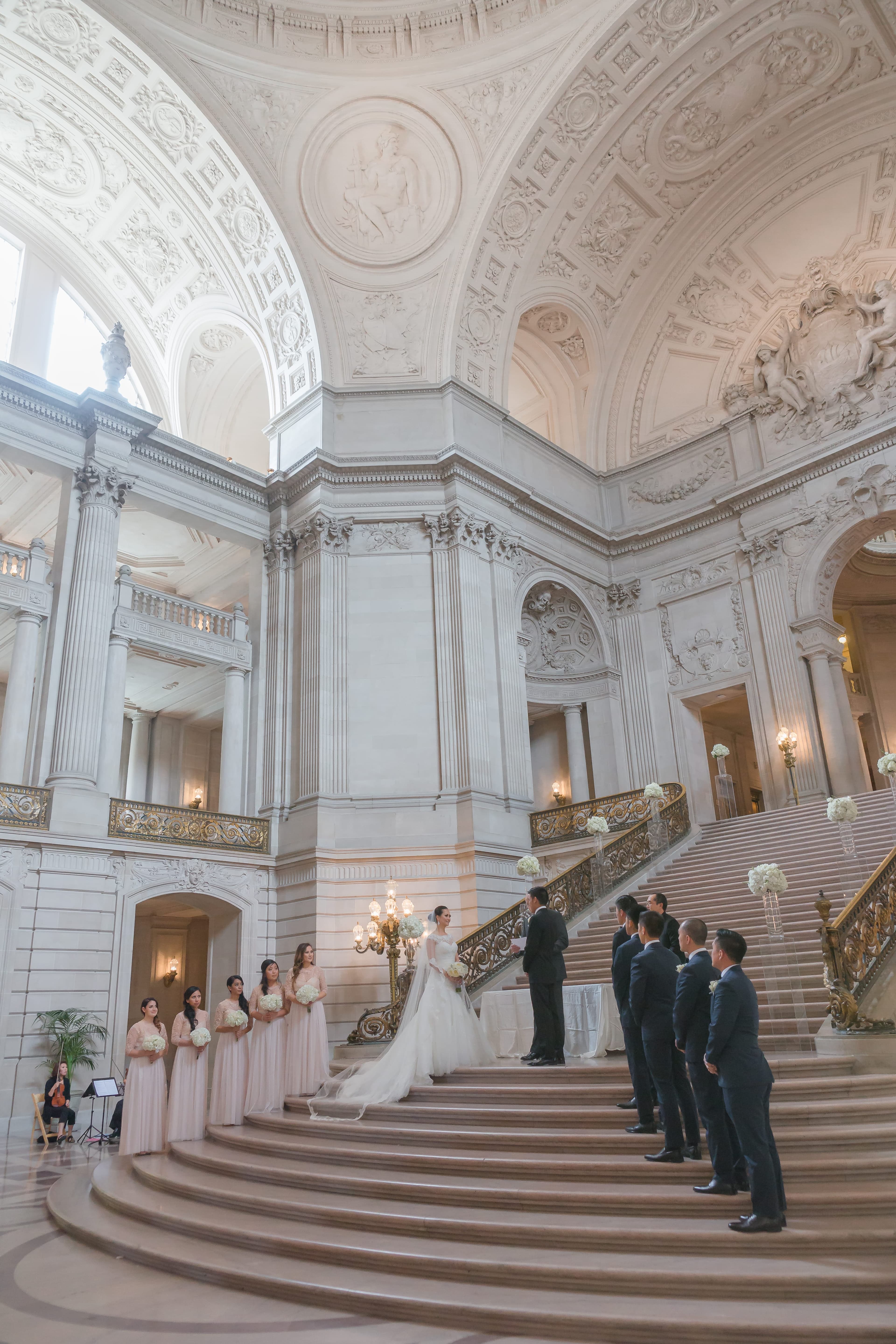 Wedding ceremony on the grand staircase of San Francisco City Hall.